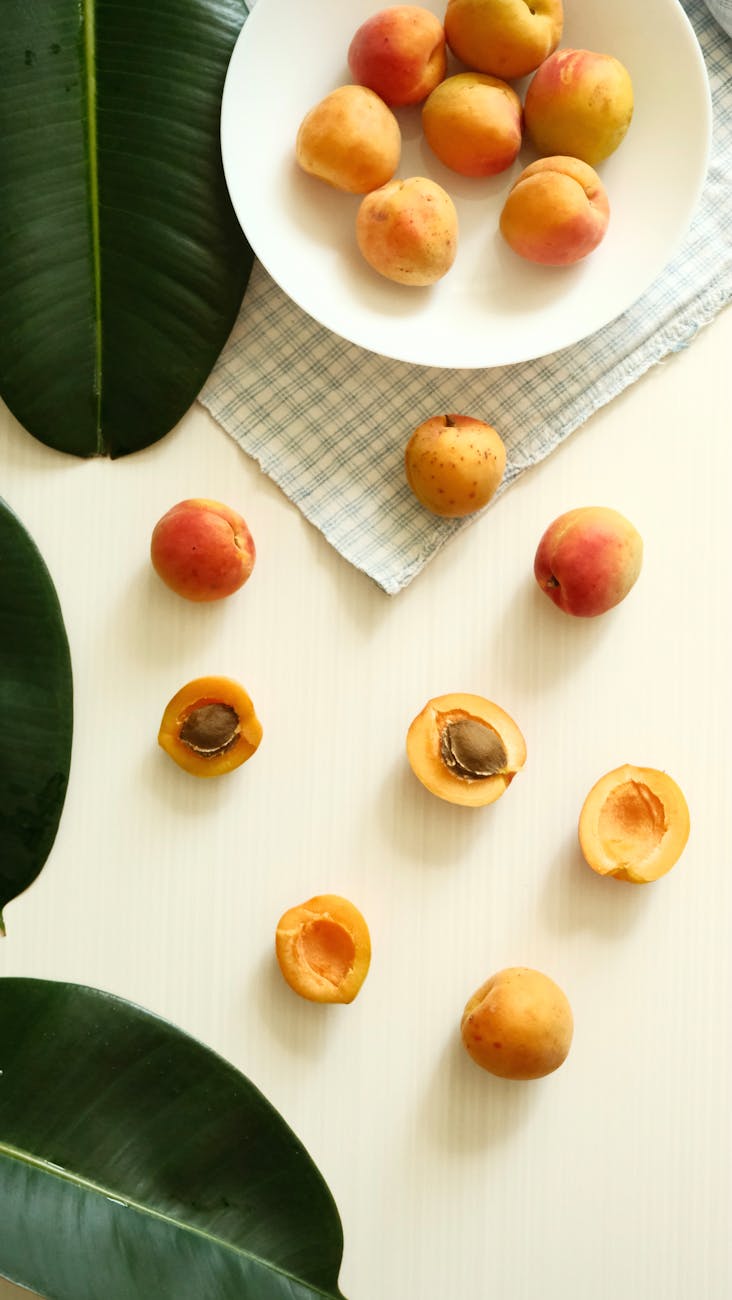 bowl of peaches on cloth